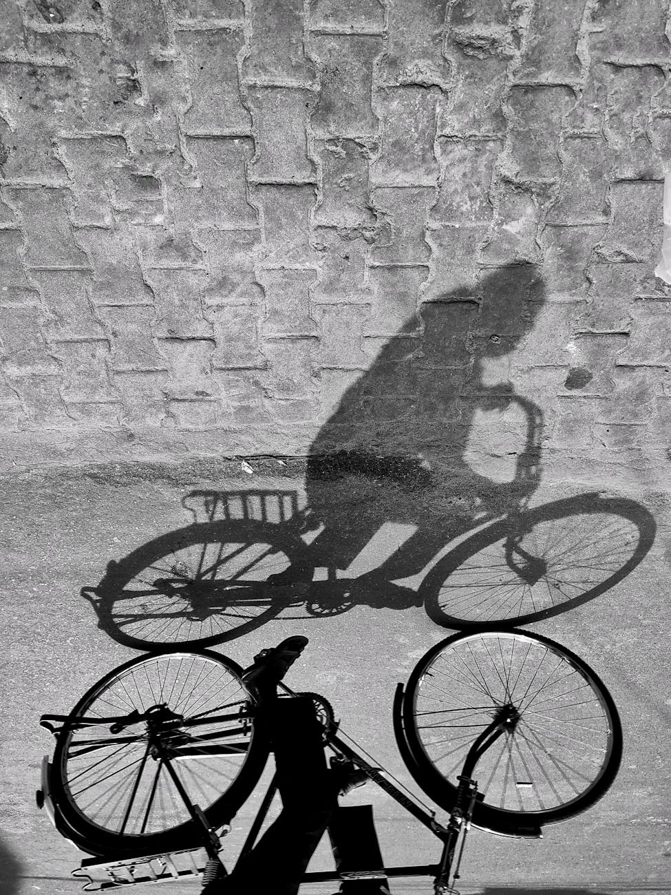 person s shadow riding bicycle